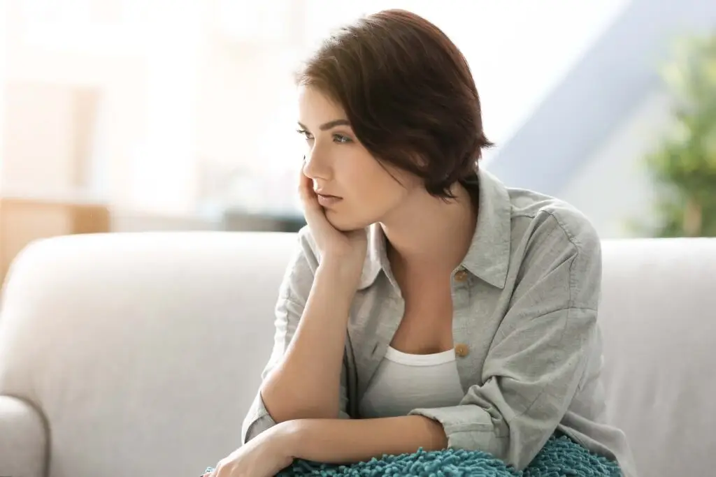 A woman contemplating why she leans toward conflict avoidance.